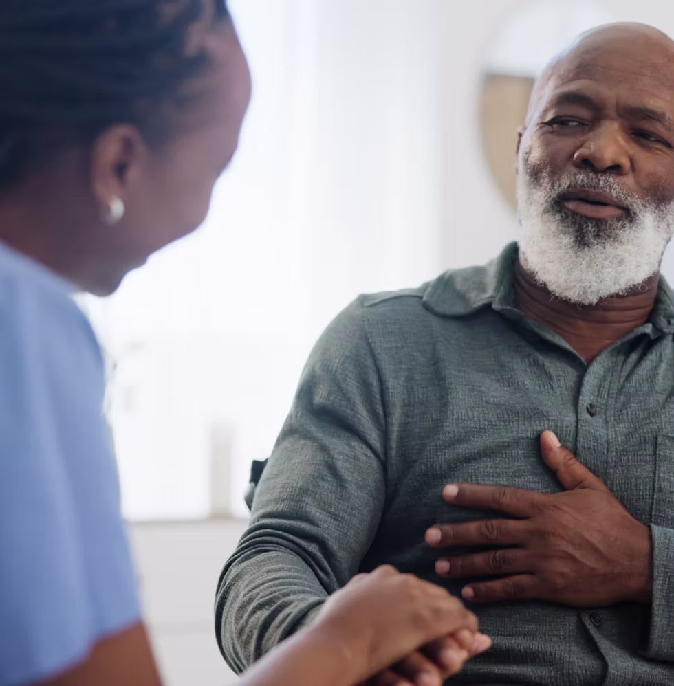 A home health professional listening attentively to an older adult